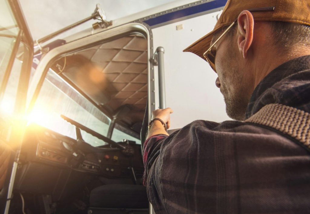 Professional Truck Driver Getting Into a Truck